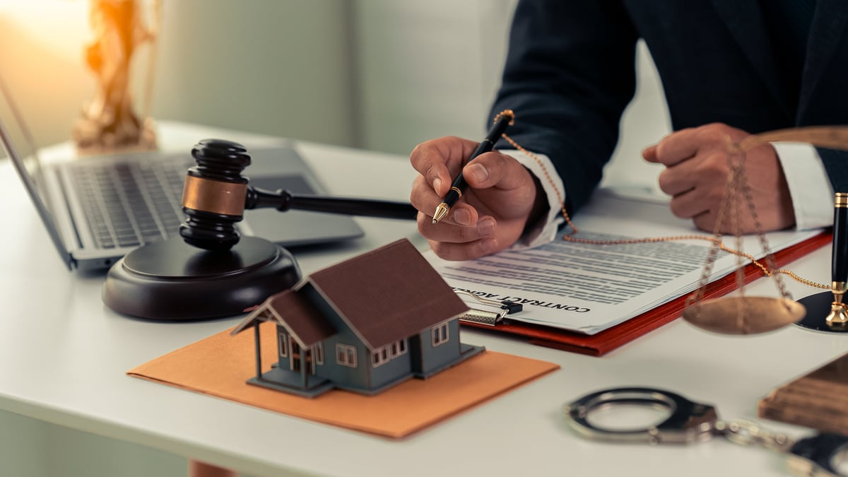 Real estate professional working with documents on a home sale